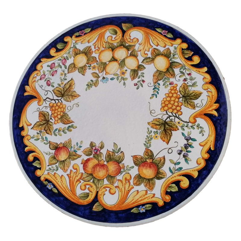 Tavolo tondo in pietra lavica ceramizzata Modello Positano Foglie e Frutta dipinto a mano. Ceramica di Vietri